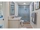 Bright bathroom featuring a glass enclosed shower, stylish vanity, and modern fixtures at 11007 Lake Katherine Cir, Clermont, FL 34711