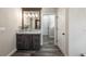 Bathroom featuring a dark wood vanity, marble countertop and flooring, and modern lighting at 11007 Lake Katherine Cir, Clermont, FL 34711