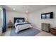 Bedroom with white walls and a blue rug, featuring a view of a TV screen at 11007 Lake Katherine Cir, Clermont, FL 34711