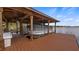 Covered boat lift with a pontoon boat, providing convenient lake access and storage at 11007 Lake Katherine Cir, Clermont, FL 34711