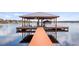 Private boat dock featuring a covered boat lift, providing convenient lake access and storage at 11007 Lake Katherine Cir, Clermont, FL 34711