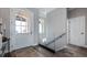 A bright entryway featuring an arched doorway and a modern glass staircase railing at 11007 Lake Katherine Cir, Clermont, FL 34711