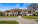 Charming single-story home with a well-manicured lawn and beautiful stone walkway at 11007 Lake Katherine Cir, Clermont, FL 34711