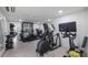 Well-equipped home gym featuring modern exercise machines and weightlifting equipment at 11007 Lake Katherine Cir, Clermont, FL 34711