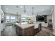 Open kitchen with island seating, farmhouse sink, and seamless flow into the living space at 11007 Lake Katherine Cir, Clermont, FL 34711
