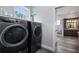 A modern laundry room featuring front load washer and dryer and natural light at 11007 Lake Katherine Cir, Clermont, FL 34711
