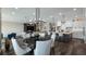 Open-concept living area with modern lighting, spacious seating, and a seamless flow into the kitchen at 11007 Lake Katherine Cir, Clermont, FL 34711
