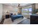 Serene main bedroom with dark wood floors, a plush bed, and a scenic waterfront view at 11007 Lake Katherine Cir, Clermont, FL 34711