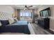 Inviting main bedroom features a plush bed, elegant nightstands, and a tranquil view of the lake at 11007 Lake Katherine Cir, Clermont, FL 34711