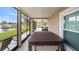 Enclosed patio featuring a hot tub with views of the lake at 11007 Lake Katherine Cir, Clermont, FL 34711