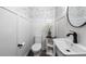 Chic powder room features modern fixtures, stylish wallpaper, and elegant wainscoting at 11007 Lake Katherine Cir, Clermont, FL 34711
