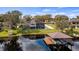Backyard view of a luxurious home with a private dock and boat lift on a serene lake at 11007 Lake Katherine Cir, Clermont, FL 34711