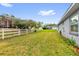 Well-maintained backyard with expansive lawn and mature trees for outdoor enjoyment at 11396 Se 178Th Pl, Summerfield, FL 34491