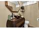 Stylish bathroom features a unique copper sink and an ornate mirror, with neutral tones and wooden accents at 11396 Se 178Th Pl, Summerfield, FL 34491