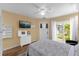 Bedroom with a serene atmosphere, large window, and convenient access to the outdoors, creating a peaceful sanctuary at 11396 Se 178Th Pl, Summerfield, FL 34491