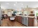 Open-concept kitchen featuring island with granite counters and stainless steel appliances at 11396 Se 178Th Pl, Summerfield, FL 34491