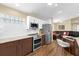 Well-lit kitchen featuring stainless steel appliances and two-tone cabinetry at 11396 Se 178Th Pl, Summerfield, FL 34491