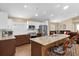 Well-lit kitchen featuring a spacious island with granite counters and seating at 11396 Se 178Th Pl, Summerfield, FL 34491