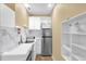 Compact kitchenette featuring modern appliances, marble backsplash, and ample storage, ideal for small living spaces at 11396 Se 178Th Pl, Summerfield, FL 34491
