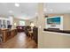 Spacious living room featuring hardwood floors, recessed lighting, and a large TV at 11396 Se 178Th Pl, Summerfield, FL 34491