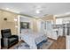 Multipurpose studio with a murphy bed, sleek white cabinetry, and a small kitchenette, maximizing space and functionality at 11396 Se 178Th Pl, Summerfield, FL 34491