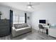 Bright bedroom setup as a home office with a futon, desk, and modern decor at 11684 Sw 72Nd Cir, Ocala, FL 34476