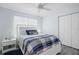 Cozy bedroom featuring a white bed frame and blue accents, with ample closet space at 11684 Sw 72Nd Cir, Ocala, FL 34476
