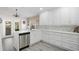 Contemporary kitchen featuring white cabinets, stainless steel dishwasher, and quartz countertops at 11684 Sw 72Nd Cir, Ocala, FL 34476