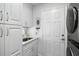 Efficient laundry area with sink, storage, and washer/dryer at 11684 Sw 72Nd Cir, Ocala, FL 34476