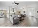 Bright, open-concept living space with modern floors, seamlessly connecting the living, dining, and kitchen areas at 11684 Sw 72Nd Cir, Ocala, FL 34476