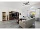 Bright and airy living area with modern flooring, stylish furnishings, and a large window providing natural light at 11684 Sw 72Nd Cir, Ocala, FL 34476