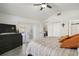 Comfortable bedroom with a ceiling fan, closet, and a view to the backyard through the glass doors at 11684 Sw 72Nd Cir, Ocala, FL 34476