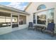 Outdoor patio area with chairs and view to screened lanai at 11684 Sw 72Nd Cir, Ocala, FL 34476