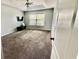 Neutral Primary bedroom featuring soft carpet and a large window at 11727 Pineloch Loop, Clermont, FL 34711