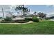 Neighborhood entrance featuring the Pineloch sign with lush landscaping at 11727 Pineloch Loop, Clermont, FL 34711