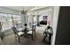 Cozy dining room with a glass table, natural light, and an open concept design at 11727 Pineloch Loop, Clermont, FL 34711