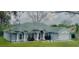 Charming single-story home with blue exterior, white trim, well-manicured lawn, and an attached two-car garage at 11727 Pineloch Loop, Clermont, FL 34711