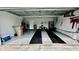 Garage with epoxy floor, painted walls, and organized storage at 11727 Pineloch Loop, Clermont, FL 34711