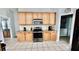Bright kitchen featuring stainless steel appliances and wooden cabinets at 11727 Pineloch Loop, Clermont, FL 34711