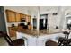Well-equipped kitchen featuring wooden cabinets, granite countertops, and modern appliances at 11727 Pineloch Loop, Clermont, FL 34711
