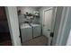 Functional laundry room equipped with a washer, dryer, and convenient shelving at 11727 Pineloch Loop, Clermont, FL 34711
