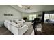 Spacious living room featuring a vaulted ceiling, cozy fireplace, and comfortable seating at 11727 Pineloch Loop, Clermont, FL 34711