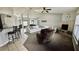 Spacious living room featuring a vaulted ceiling, cozy fireplace, and comfortable seating at 11727 Pineloch Loop, Clermont, FL 34711