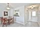 View of the dining room, kitchen, and entryway with tile floors and neutral paint at 1229 Augustine Dr, The Villages, FL 32159
