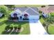 Charming single-story home with a well-manicured lawn and a long driveway leading to an attached garage at 1229 Augustine Dr, The Villages, FL 32159
