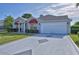 Inviting single-story home with a clean white garage door and a well-maintained front yard at 1229 Augustine Dr, The Villages, FL 32159