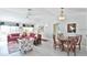 Bright living and dining area boasts neutral paint, ceiling fan, and stylish furniture at 1229 Augustine Dr, The Villages, FL 32159