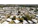 Sprawling aerial view of a vibrant mobile home community, some homes feature pools, surrounded by lush greenery and a serene lake at 1340 Elkhart Cir, Tavares, FL 32778