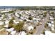 Wide aerial shot shows a dense mobile home community near a lake, offering peaceful living with easy access to the water at 1340 Elkhart Cir, Tavares, FL 32778