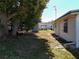 The spacious backyard shows trees providing shade on the home and yard at 1340 Elkhart Cir, Tavares, FL 32778
